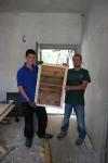 Young UK carpenters, with the result of their work, a shutter for the bell tower of the Unitarian Church, 2011